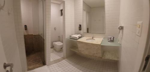 a bathroom with a sink and a toilet at Motel Decameron (Adults Only) in Salvador