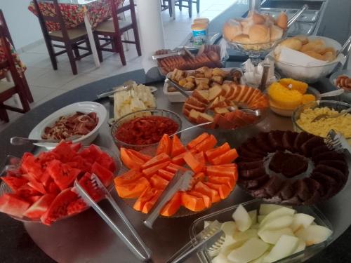 a table with many different types of food on it at Pousada La pasta beach in Valença