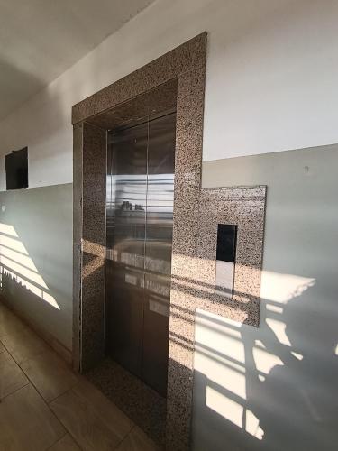a building with a door with a shadow on the wall at Acehomes Studio in Kinoo