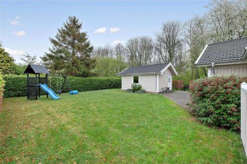 a yard with a playground and a house at LL235-Tranekaer-Kronens-Have-13 in Tranekær