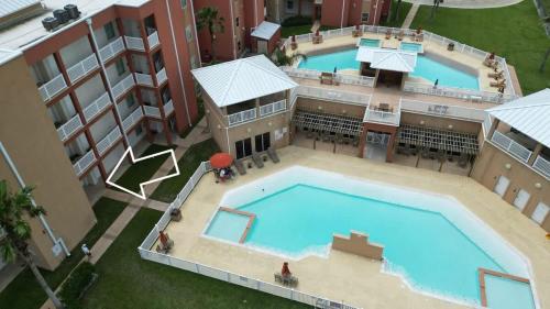 an overhead view of a swimming pool in a building at La Isla F102 condo in South Padre Island