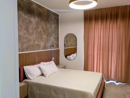 a hotel room with a bed and a mirror at Cabrí rooms in Vieste