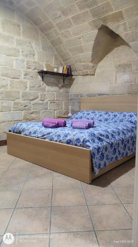 a bed in a room with two pillows on it at La Casa del Colosso in Barletta