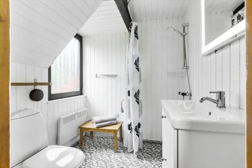 a white bathroom with a sink and a toilet at LL238-Tranekaer-Engvej-17 in Tranekær