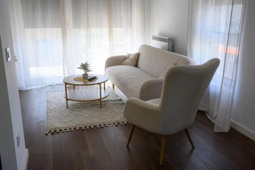 a living room with a couch and a table at Tesla Apartments 1 in Kragujevac