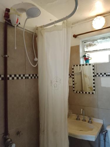 a bathroom with a shower curtain and a sink at Tiny-house in Concordia