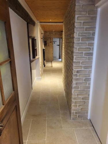 a hallway in a house with a brick wall at Appartement au pied de la forteresse in Châtel-sur-Moselle