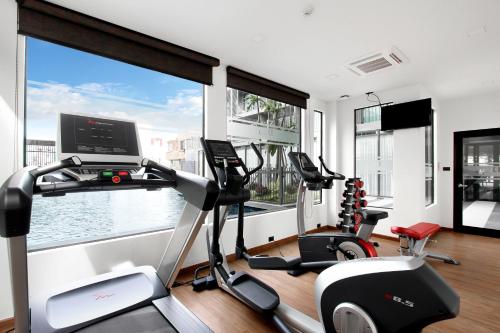 a gym with a large window and two tread machines at PLAAI Prime Hotel Rayong SHA Extra Plus in Rayong