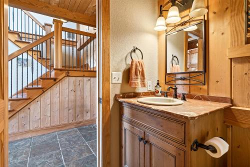 a bathroom with a sink and a staircase at Windy Path Farm in Fairview