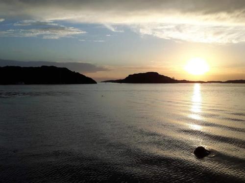 a sunset over a body of water with the sun setting at 6 person holiday home in Bovallstrand-By Traum in Bovallstrand