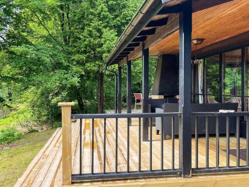 a porch of a house with a wooden deck at 6 person holiday home in KNÄRED in Knäred