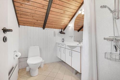 a bathroom with a toilet and a sink at C11617-Ansager-Sovej-30 in Ansager