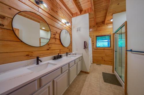 a bathroom with two sinks and a mirror at Fuji Falls Cabin in Black Mountain