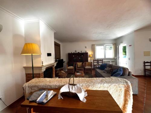 a bedroom with a bed and a living room at Casa das Oliveiras - Manteigas in Manteigas