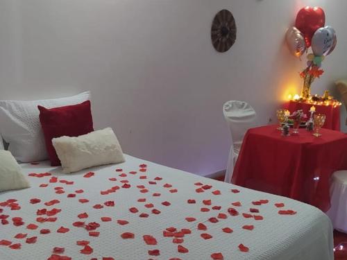 a bedroom with a bed with red hearts on it at Pousada La pasta beach in Valença