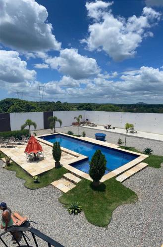 a swimming pool in front of a body of water at Espaço Vip 600 in Pacatuba