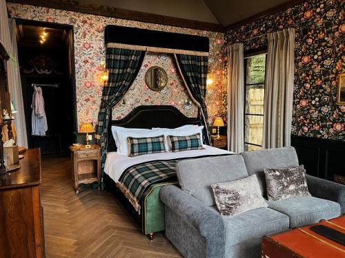 a bedroom with a bed and a couch at Glencruitten House in Oban