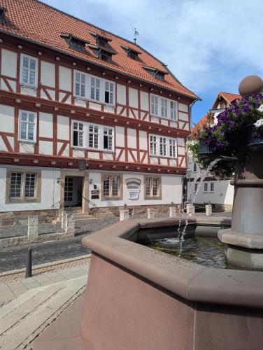 a building with a fountain in front of a building at Altes Rathaus Kassel-Wolfhagen in Wolfhagen