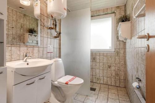 a bathroom with a toilet and a sink at C11410-Skjern-Sivvaenget-13 in Skjern