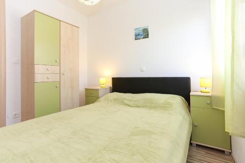 ein Schlafzimmer mit grünen Schränken und einem Bett darin in der Unterkunft Apartments Ivan in Trogir