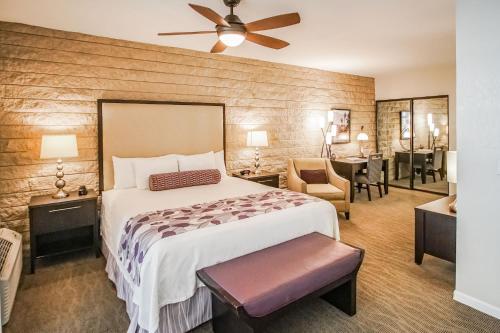 a bedroom with a bed and a desk with a chair at Palm Springs Tennis Club in Palm Springs