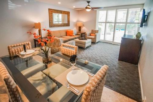 a dining room and living room with a table and chairs at Palm Springs Tennis Club in Palm Springs