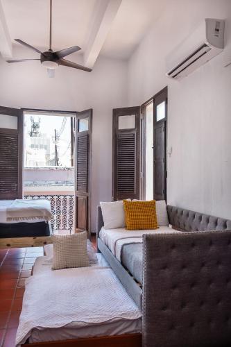 a living room with a couch and a ceiling fan at Old San Juan Rentals in San Juan