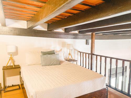 a bedroom with a white bed and a balcony at Old San Juan Rentals in San Juan