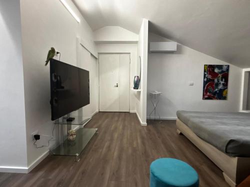 a living room with a bed and a flat screen tv at Boutique House in Benevento