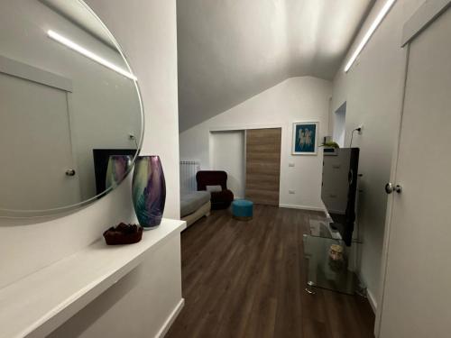 a living room with a mirror on the wall at Boutique House in Benevento