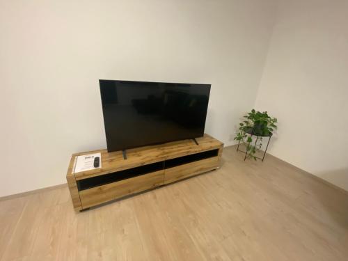 a flat screen tv sitting on top of a wooden entertainment center at Apartmány Hodonín in Hodonín