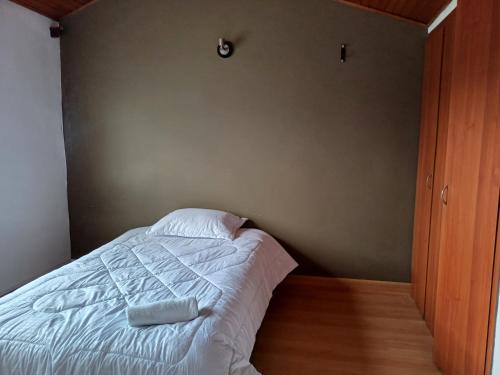 a bedroom with a bed with two towels on it at CASA BOUTIQUE Villa del Prado in Bogotá