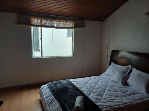 a bedroom with a bed and a window at CASA BOUTIQUE Villa del Prado in Bogotá