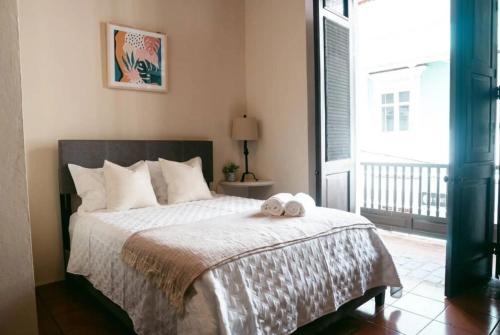a bedroom with a bed with two towels on it at Old San Juan Rentals in San Juan