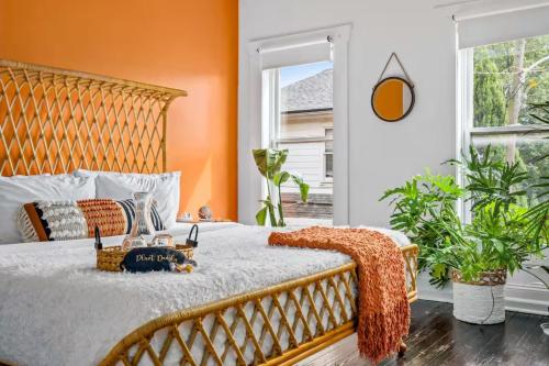 a bedroom with a large bed with an orange wall at Prime Location Top Rated Clean Parking Free! in Columbus