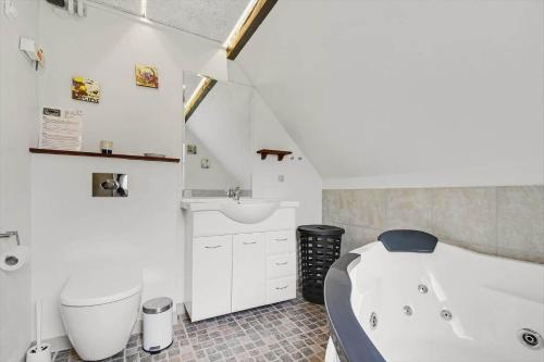 a white bathroom with a tub and a sink at C11204-Hemmet-Bowleren-1 in Hemmet