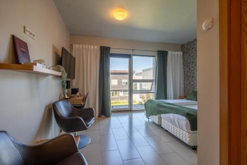 Un ou plusieurs lits dans un hébergement de l'établissement Hotel Laki