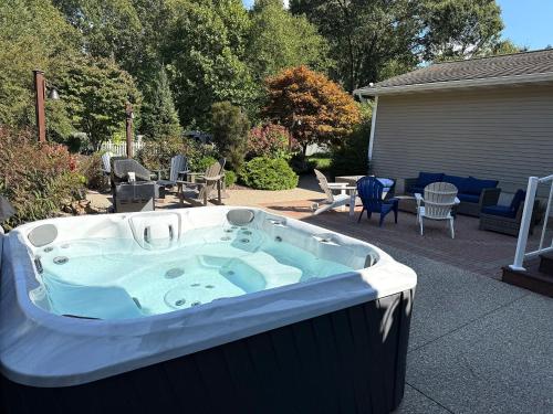 a hot tub in a yard with a patio at Keppel Cove in Saugatuck