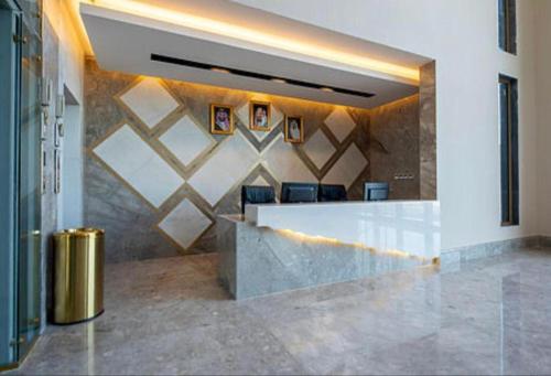 a lobby with a reception counter with chairs at كيونا للأجنحة والفلل - Kyona suites & villas in Jeddah
