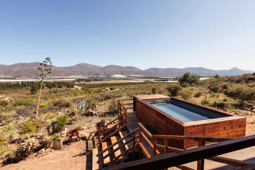 a hot tub on the deck of a house in the desert at Wolfkop Nature Reserve in Citrusdal