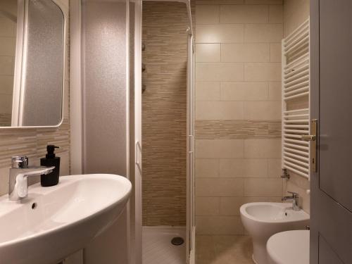 a bathroom with a sink and a toilet and a shower at Mountain Studio 109A in Breuil-Cervinia