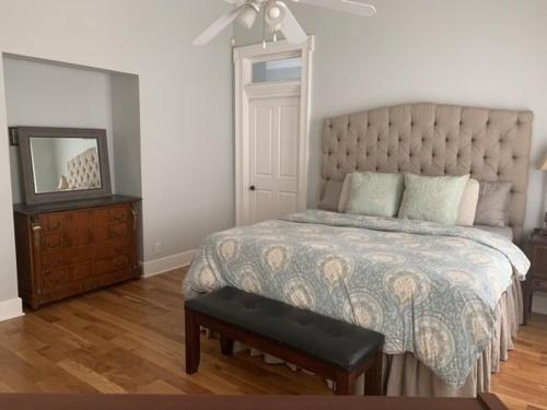 a bedroom with a bed and a dresser and a mirror at Explore Austin & San Antonio with friends & family in Kyle