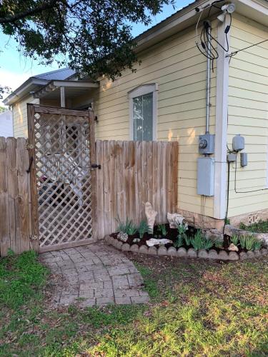 a fence with a gate in front of a house at Explore Austin & San Antonio with friends & family in Kyle