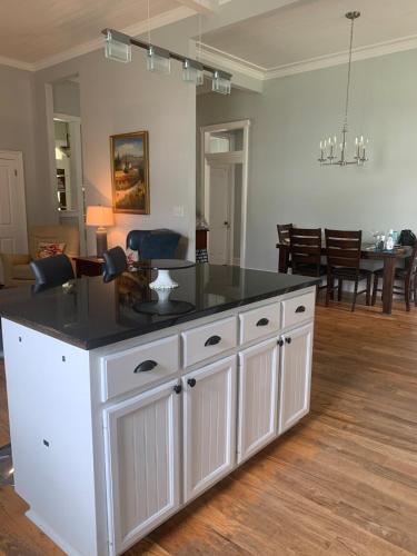 a kitchen with a white island with a black counter top at Explore Austin & San Antonio with friends & family in Kyle