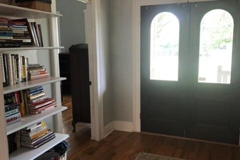 a room with a door and a book shelf with books at Explore Austin & San Antonio with friends & family in Kyle