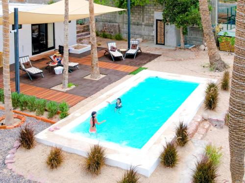 two people are playing in a swimming pool at InHouse Glamping Hotel La Paz in La Paz