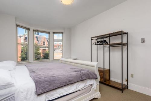 a white bedroom with a bed and a window at Capitol View Retreat - 2F Fast Wi-Fi Spacious in Harrisburg
