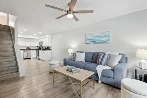 a living room with a blue couch and a table at 8664 N Atlantic Ave in Cape Canaveral