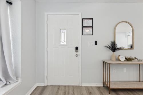 a white door in a white room with a table at 8664 N Atlantic Ave in Cape Canaveral