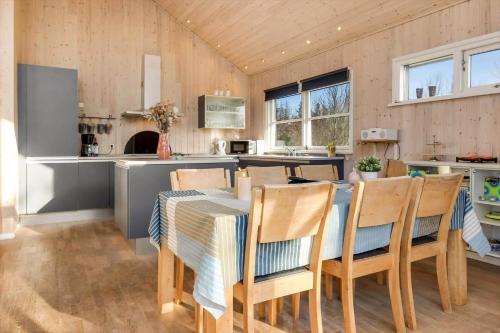 a kitchen and dining room with a table and chairs at C11308-Tarm-Stikkelsbaervej-41 in Tarm